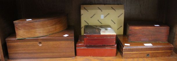 A shelf containing a selection of wooden and other storage boxes