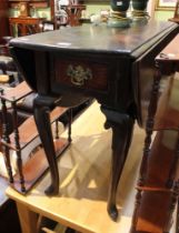 A 19th century mahogany twin-flap dining table slender top on cabriole legs with single drawer