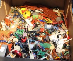 A box containing a wide selection of vintages children's plastic figures, etc