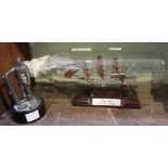 A glass ship in a bottle "Cutty Sark" together with a cast metal soldier figure (2)
