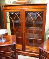 A reproduction glazed fronted two door display cabinet