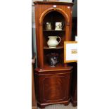 A reproduction corner cupboard with open shelves above a cupboard base