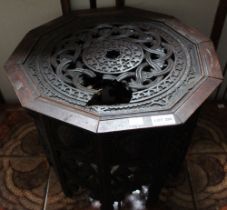 A Indo/Persian decagon hardwood occasional table, having a frieze of shield bosses over pierced & ca