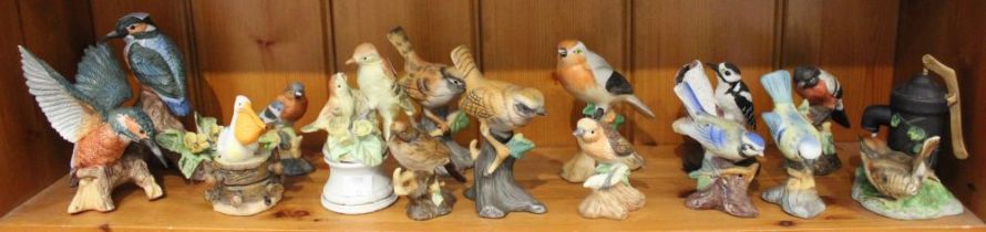A box containing a selection of ceramic model birds various