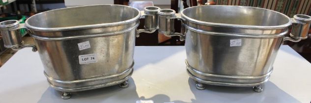 Kenneth Turner, a pair of American pewter ice buckets, fitted handles raised on four button feet, 17