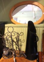 A pine framed wall mirror, wrought iron frame of fireside tools, coal scuttle and wine rack