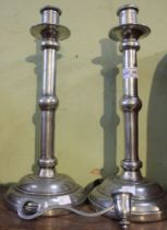 Kenneth Turner (American pewter) a pair of knopped stem candlesticks, on domed circular platform bas