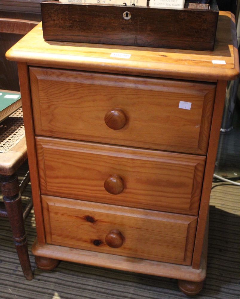 A small pine chest of three drawers