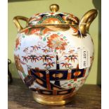 A 19th century Spode porcelain potpourri, fitted two gilded handles, painted and gilded in the Imari