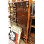 A mid century teak display cabinet with smoked glazed doors and glass internal shelves