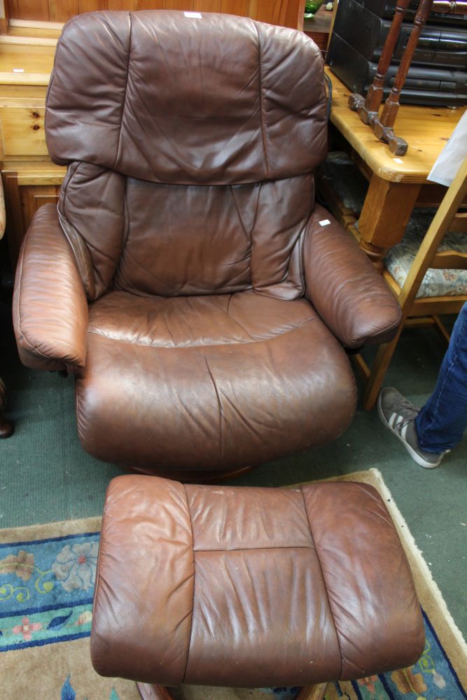 A Ekornes stressless leather armchair with matching foot stool