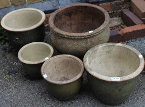 A set of five garden pots with resident snail!