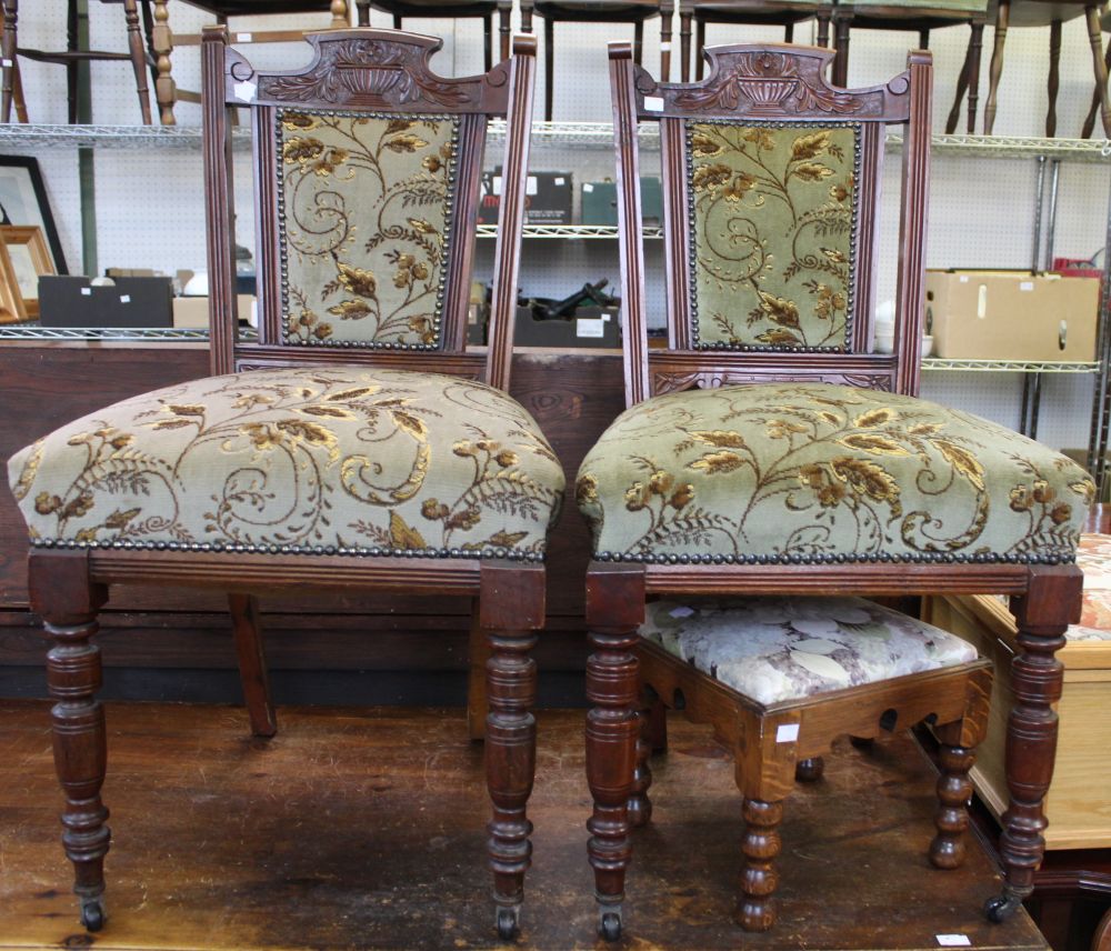 A pair of Edwardian dining chairs with upholstered seats and backs