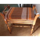 An Edwardian mahogany piano stool with lift up seat