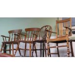 An oak carver chair together with a wheel back kitchen chair
