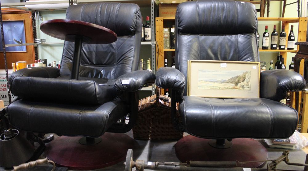 A pair of leather swivel recliner easy chairs with polished wooden base, together with one foot stoo