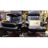 A pair of leather swivel recliner easy chairs with polished wooden base, together with one foot stoo