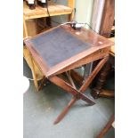 A 19th century mahogany sloping scribes desk on x-frame support with skiver inset