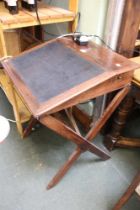 A 19th century mahogany sloping scribes desk on x-frame support with skiver inset