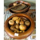 A collection of wooden bowls and wooden fruits