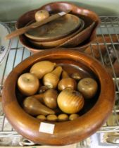 A collection of wooden bowls and wooden fruits