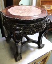 A highly carved mahogany Oriental style table with marble inset top