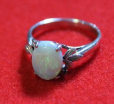 An opal set white metal ring, (stamped 18k, but tested as silver)