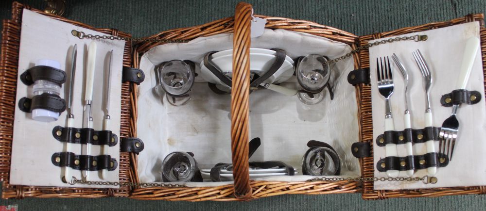 A vintage wicker hamper for four people, complete with contents, basket having carrying handle & lea