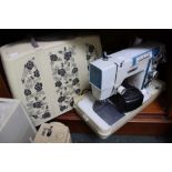 A vintage Jones electric oeddle sewing machine in carry case