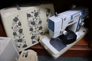 A vintage Jones electric oeddle sewing machine in carry case