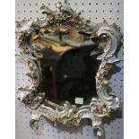 A porcelain framed mirror, in the Rococo taste, having polished wood back, overall size 39cm x 32cm