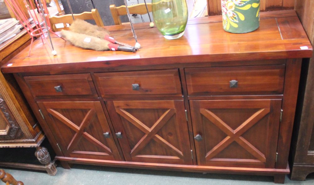 A modern sideboard, hard wood three drawer over three cupboard doors