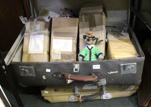 A collection of Meercat toys, two suitcases and a briefcase