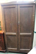 An oak two door wardrobe with fitted interior