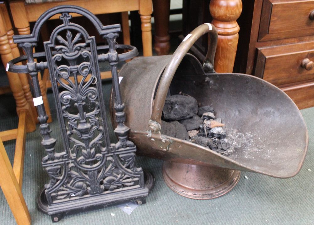 A copper coal scuttle with contents with a cast iron stick/umbrella stand