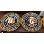 Gebruder - A pair of Austrian pottery chargers, moulded decoration of children 31cm diameter