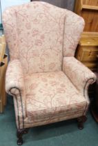 A substantial re-upholstered wing back armchair