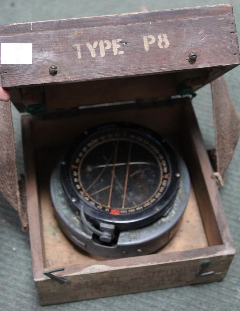 A WWII 1942 compass in original wooden carrying case