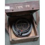 A WWII 1942 compass in original wooden carrying case