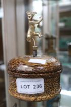 A trinket box, turned wood with a gilded silver model of "Tigger" mounted upon a spring to the coffe