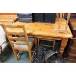 A small pine kitchen table with four beech and drop-in upholstered chairs