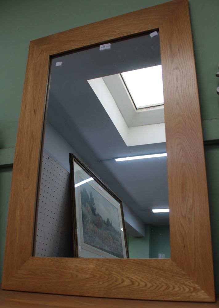 A modern beech frame wall mirror