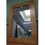 A modern beech frame wall mirror