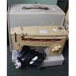 A vintage Singer 538 sewing machine with electric pedal in original carry case