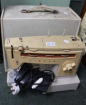 A vintage Singer 538 sewing machine with electric pedal in original carry case