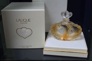 A Lalique perfume bottle, designed as conjoined hearts, still full and in original packaging, with l