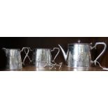 A three piece silver plated Walker & Hall metal tea set, decorated with Herons catching fish, togeth