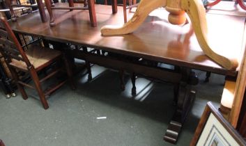 A dark oak tavern style dining table on twin liar style legs pegged stretcher 84 x 198 cm