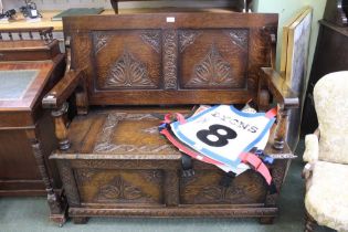 An oak carved monks bench of traditional shape and form