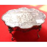 A Dutch silver table casket in the form of a Rococo form centre table, the hinged top embossed with